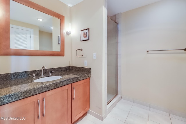 bathroom featuring vanity, walk in shower, and tile patterned flooring