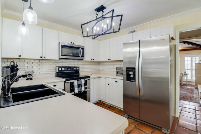 kitchen with stainless steel appliances, crown molding, and a sink