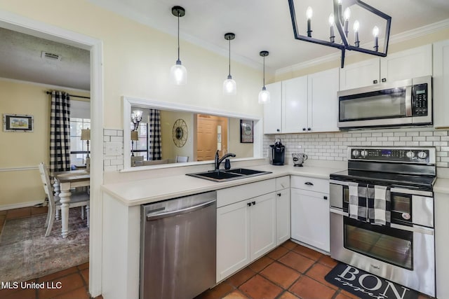 kitchen with tasteful backsplash, visible vents, appliances with stainless steel finishes, and a sink