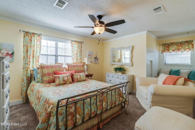 bedroom featuring visible vents, carpet, crown molding, and a textured ceiling