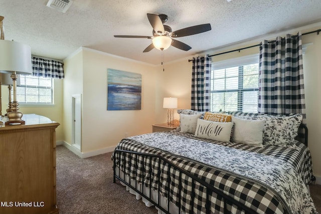 bedroom featuring visible vents, multiple windows, a textured ceiling, and carpet floors