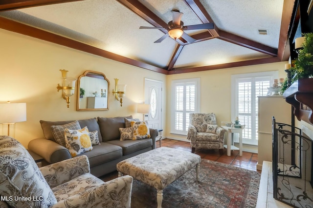 tiled living room with a ceiling fan, a textured ceiling, visible vents, and vaulted ceiling with beams