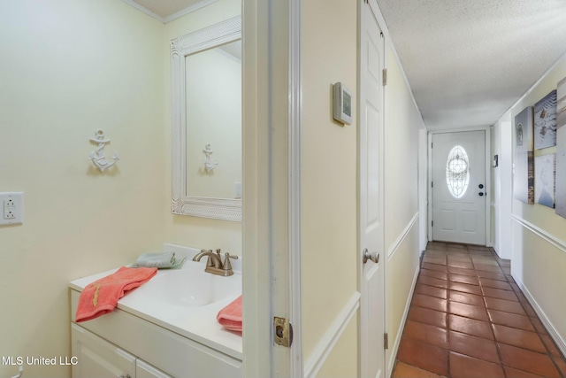 interior space featuring tile patterned floors, a textured ceiling, and vanity