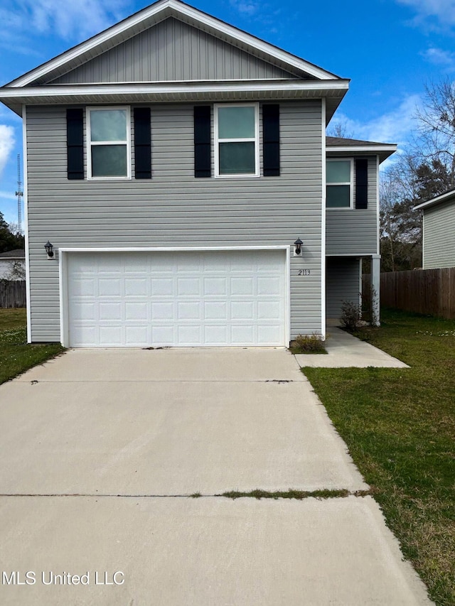 view of front of property featuring a front yard, an attached garage, fence, and driveway