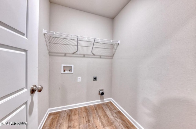 laundry area with baseboards, washer hookup, laundry area, wood finished floors, and electric dryer hookup