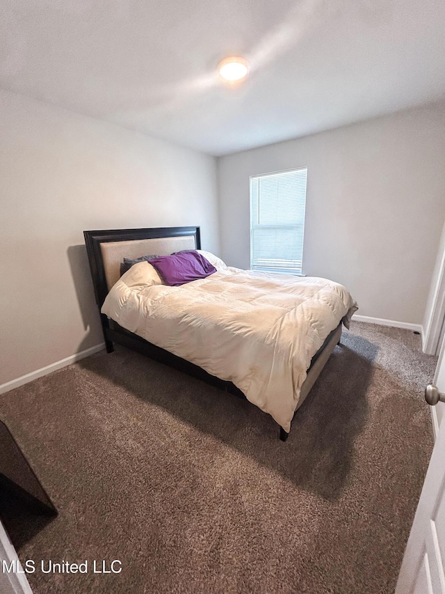 bedroom with baseboards and carpet floors