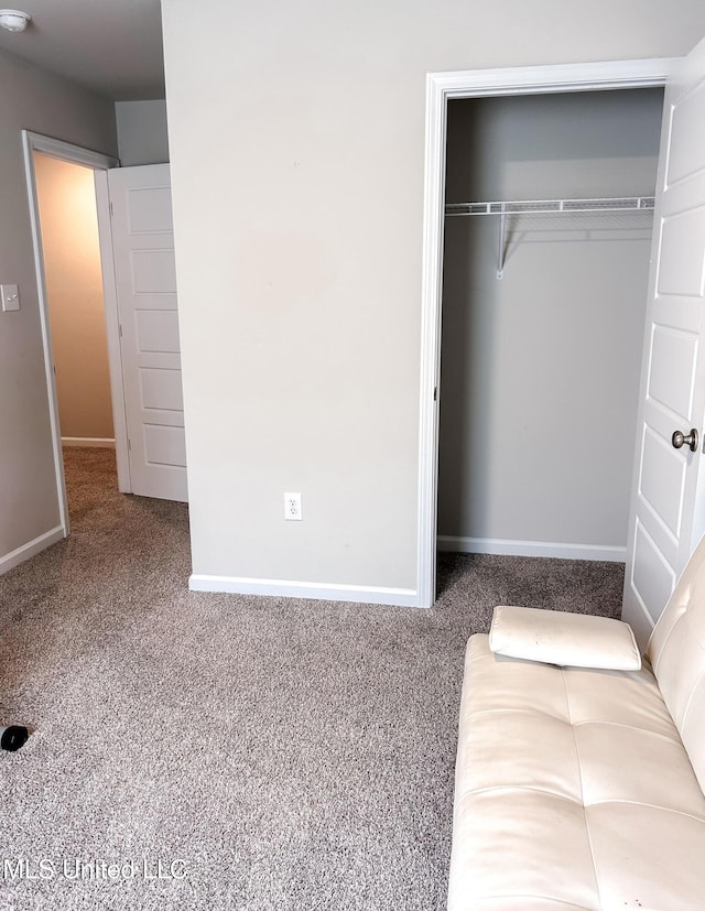 unfurnished bedroom with a closet, baseboards, and carpet floors