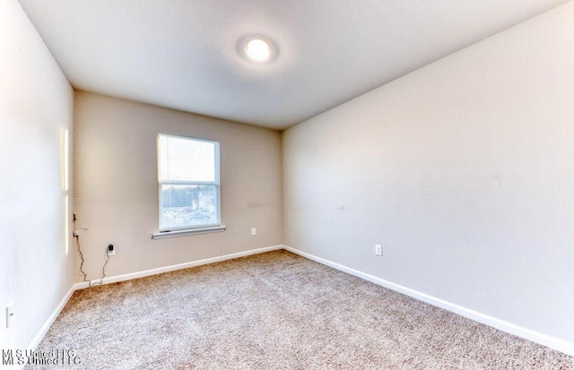 carpeted empty room with baseboards