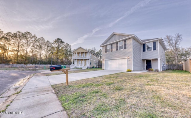 view of front of property with a garage, concrete driveway, a front yard, and fence