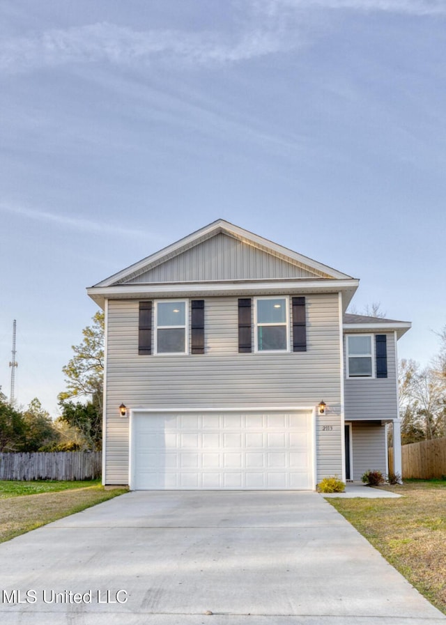 view of front of property with concrete driveway, an attached garage, fence, and a front yard