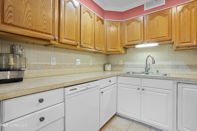 kitchen featuring light tile patterned floors, light countertops, visible vents, a sink, and dishwasher