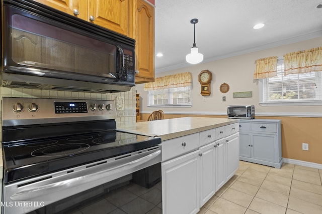 kitchen featuring light tile patterned floors, stainless steel electric stove, light countertops, ornamental molding, and black microwave