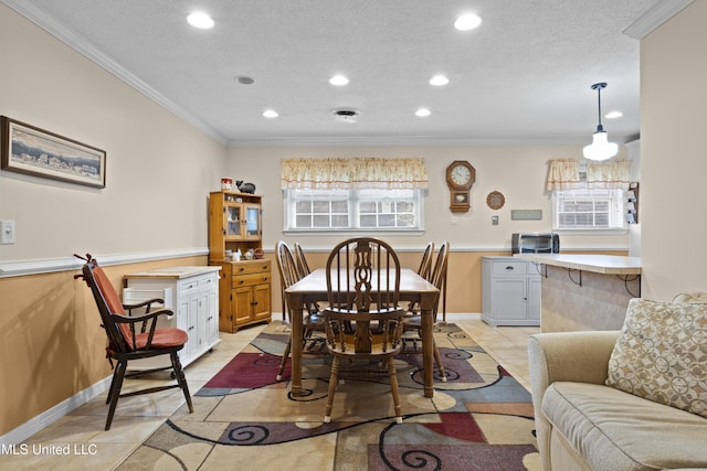 dining room with ornamental molding, recessed lighting, light tile patterned flooring, and a textured ceiling