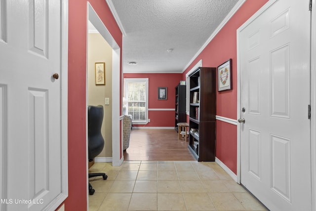 office area with light tile patterned floors, ornamental molding, a textured ceiling, and baseboards