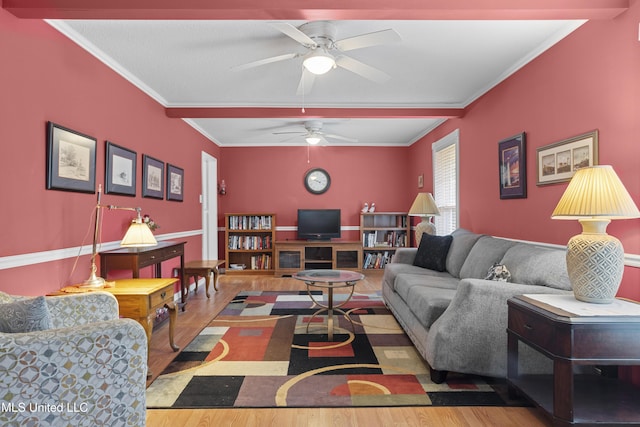 living room featuring ceiling fan, wood finished floors, and crown molding