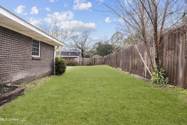 view of yard with a fenced backyard