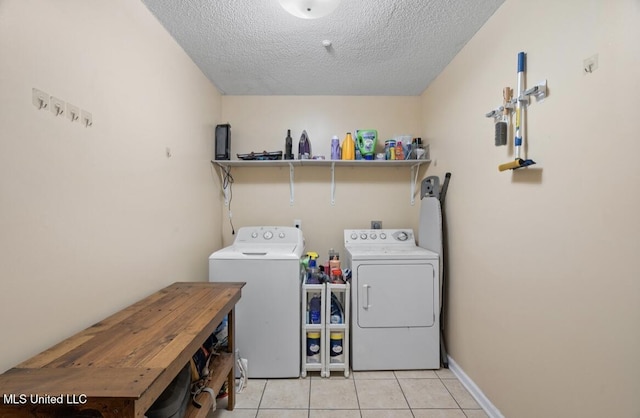 7669 Meadow Ridge Ln, Olive Branch, MS 38654 - laundry room featuring washing machine and dryer, light tile patterned floors, and a textured ceiling