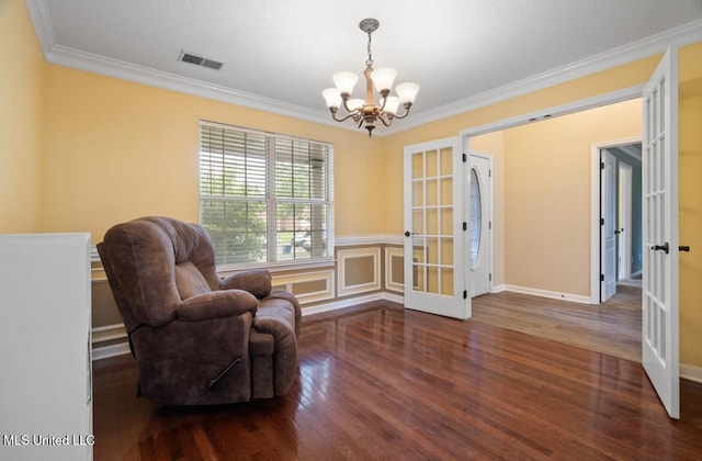 7669 Meadow Ridge Ln, Olive Branch, MS 38654 - sitting room with french doors, a chandelier, wood finished floors, and ornamental molding