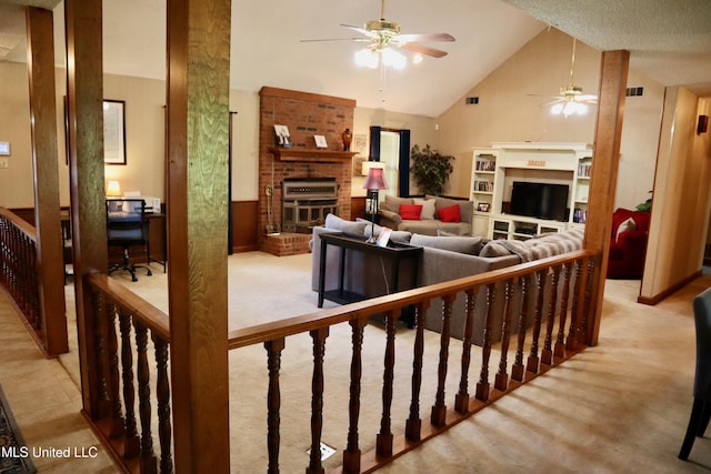 2440 E Church Rd, Southaven, MS 38671 - living room with a brick fireplace, ceiling fan, high vaulted ceiling, and carpet floors