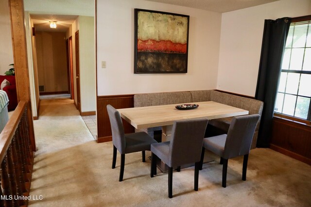 2440 E Church Rd, Southaven, MS 38671 - dining space with carpet flooring, wainscoting, and wooden walls