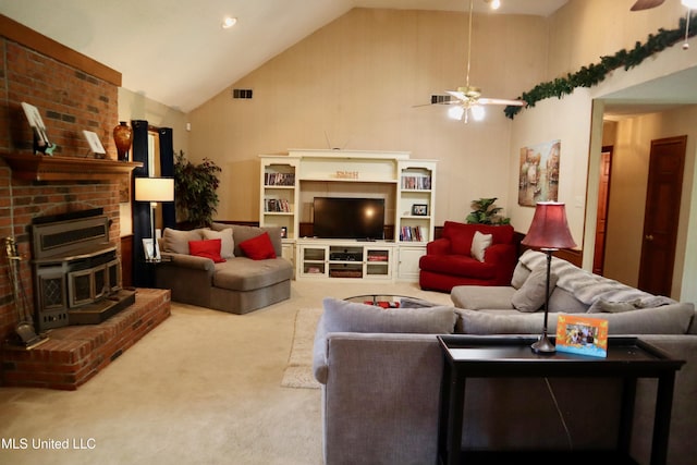 2440 E Church Rd, Southaven, MS 38671 - living room featuring a ceiling fan, high vaulted ceiling, carpet, a brick fireplace, and a wood stove
