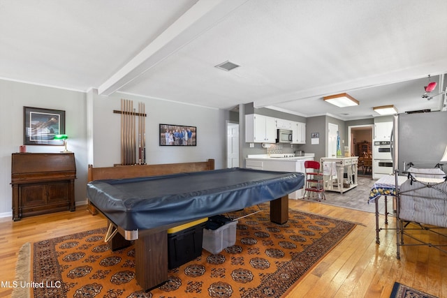 game room featuring light hardwood / wood-style flooring, crown molding, beamed ceiling, and billiards