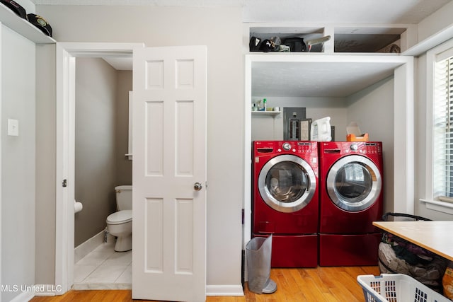 laundry room featuring hardwood / wood-style floors and washing machine and dryer