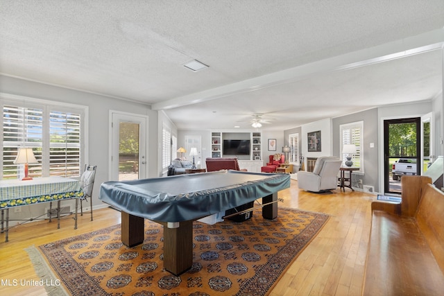 game room with a textured ceiling, hardwood / wood-style flooring, billiards, and ceiling fan