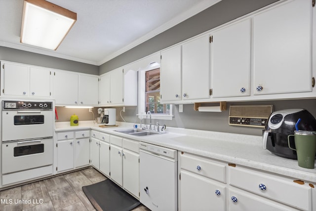 kitchen with white appliances, white cabinetry, and ornamental molding