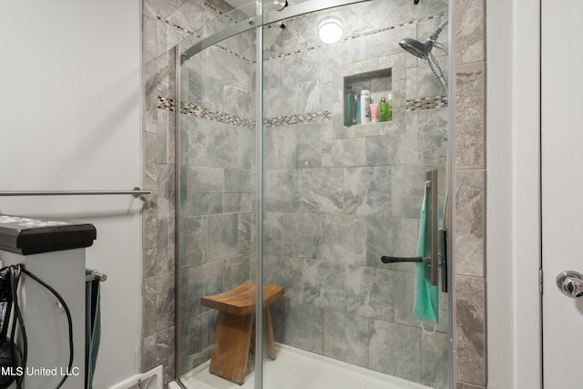 bathroom featuring a shower with shower door