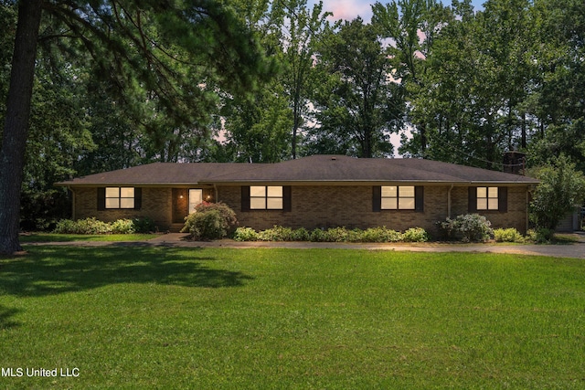 ranch-style home with a lawn