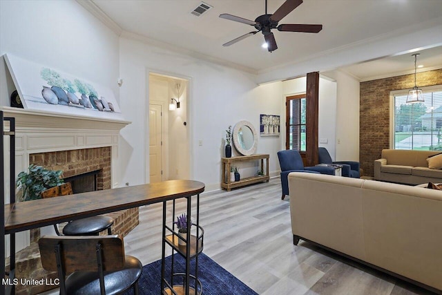 131 Stillhouse Creek Dr, Madison, MS 39110 - living area featuring ceiling fan, light wood-style floors, a brick fireplace, crown molding, and baseboards