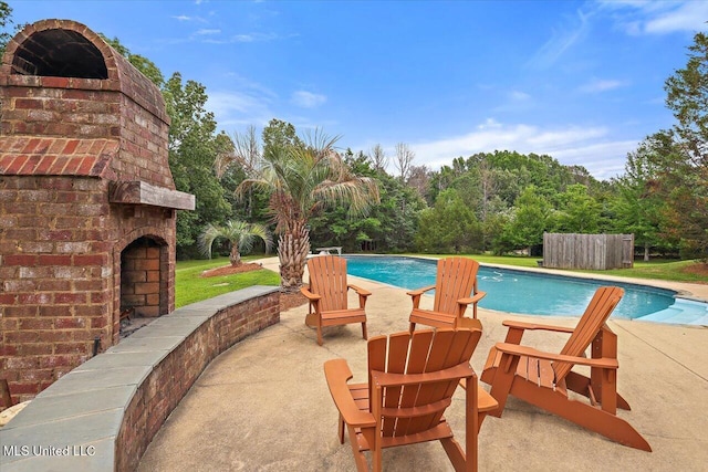 210 Planters Grv, Brandon, MS 39047 - swimming pool with an outdoor brick fireplace and a patio area