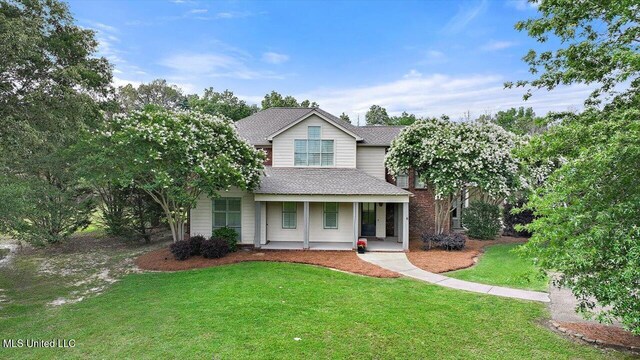 210 Planters Grv, Brandon, MS 39047 - traditional-style home with covered porch, a front lawn, and a shingled roof