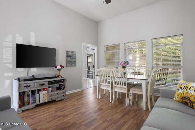 6507 Shoshonee Dr, Ocean Springs, MS 39564 - dining area with wood finished floors, a ceiling fan, a towering ceiling, and baseboards
