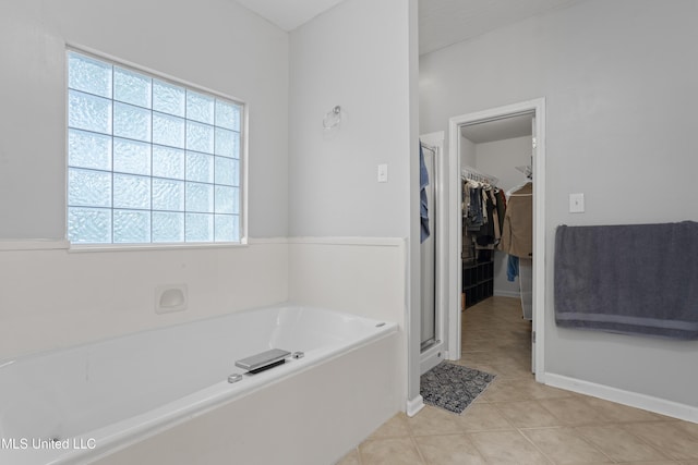 6507 Shoshonee Dr, Ocean Springs, MS 39564 - bathroom with a garden tub, a spacious closet, tile patterned flooring, and a stall shower