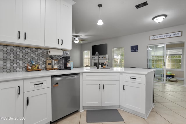 6507 Shoshonee Dr, Ocean Springs, MS 39564 - kitchen featuring dishwasher, a sink, a peninsula, tasteful backsplash, and white cabinetry