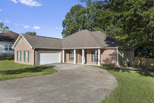 6507 Shoshonee Dr, Ocean Springs, MS 39564 - view of front of house with brick siding, driveway, a garage, roof with shingles, and a porch