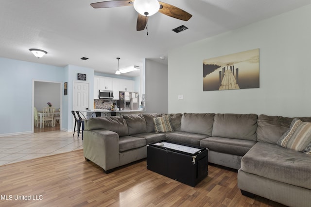 6507 Shoshonee Dr, Ocean Springs, MS 39564 - living room featuring ceiling fan, light wood-type flooring, and baseboards