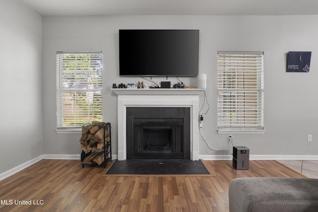 6507 Shoshonee Dr, Ocean Springs, MS 39564 - detailed view of wood finished floors, a fireplace with flush hearth, and baseboards