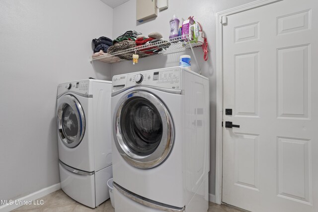 6507 Shoshonee Dr, Ocean Springs, MS 39564 - laundry area featuring independent washer and dryer, baseboards, and light tile patterned floors
