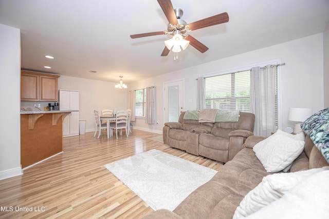 18108 Steamer Way, Gulfport, MS 39503 - living area with a chandelier, light wood-style floors, baseboards, a ceiling fan, and recessed lighting