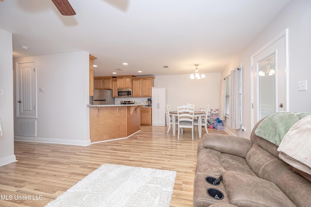 18108 Steamer Way, Gulfport, MS 39503 - living area featuring light wood finished floors, baseboards, a chandelier, a ceiling fan, and recessed lighting