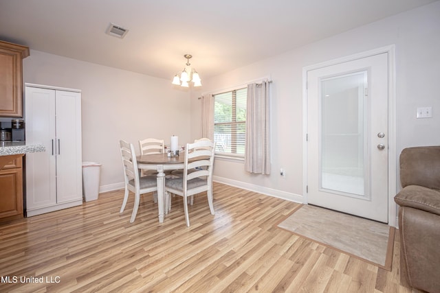 18108 Steamer Way, Gulfport, MS 39503 - dining area featuring light wood-style flooring, a chandelier, and baseboards