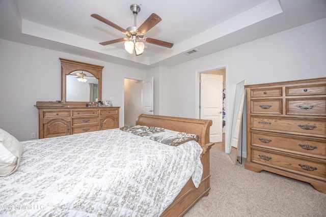 18108 Steamer Way, Gulfport, MS 39503 - bedroom with a raised ceiling, light carpet, and a ceiling fan