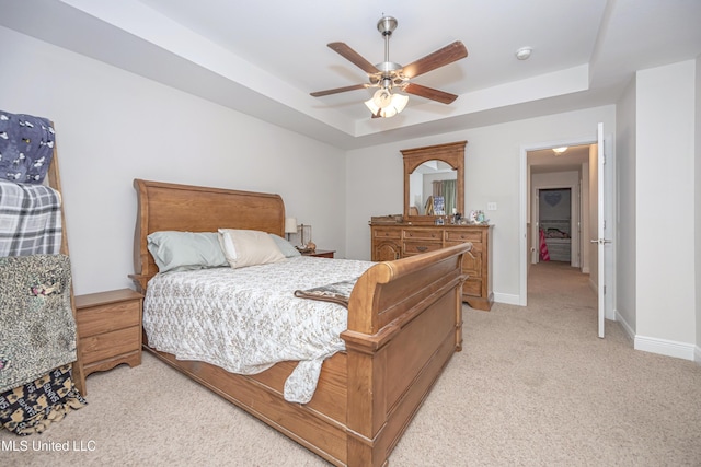 18108 Steamer Way, Gulfport, MS 39503 - bedroom with a tray ceiling, light carpet, baseboards, and ceiling fan
