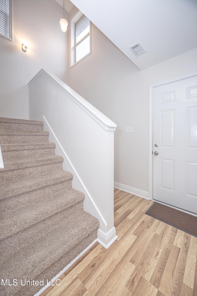 18108 Steamer Way, Gulfport, MS 39503 - entrance foyer with wood finished floors, baseboards, and stairway