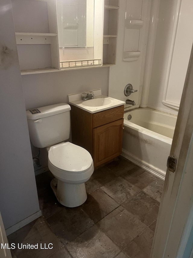 full bath featuring stone tile floors, toilet, vanity, and shower / tub combination