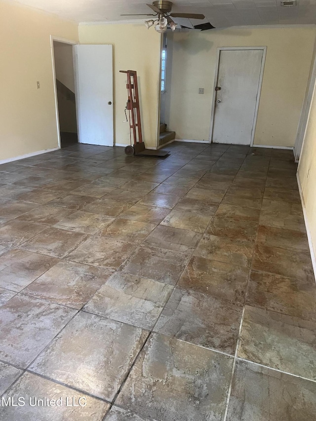 unfurnished room with baseboards and ceiling fan