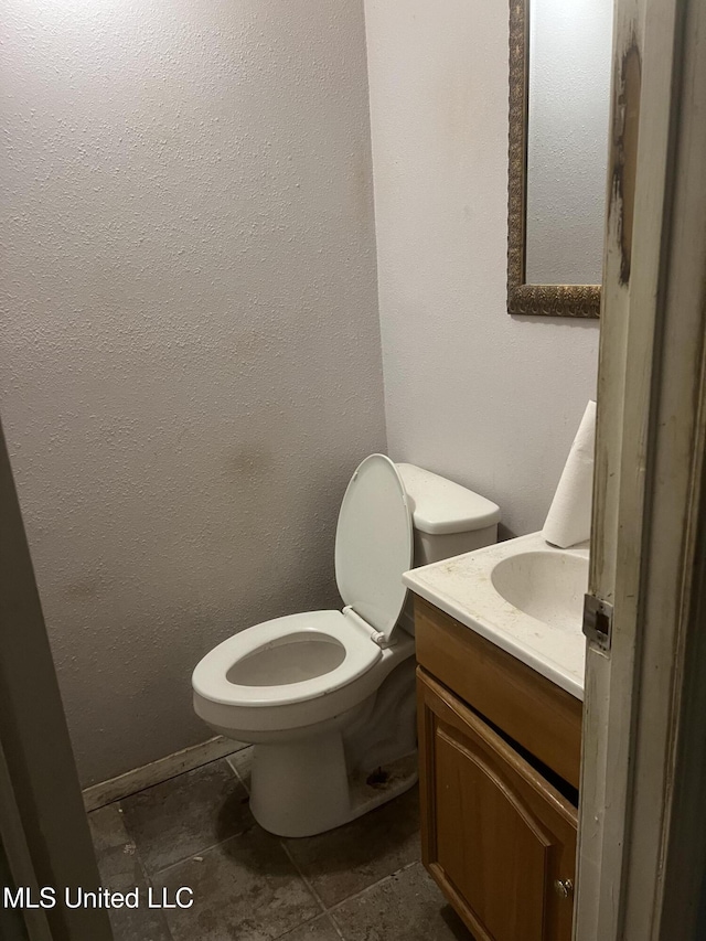 half bath featuring toilet and vanity